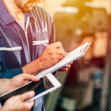 A side view of a guy fixing a table.